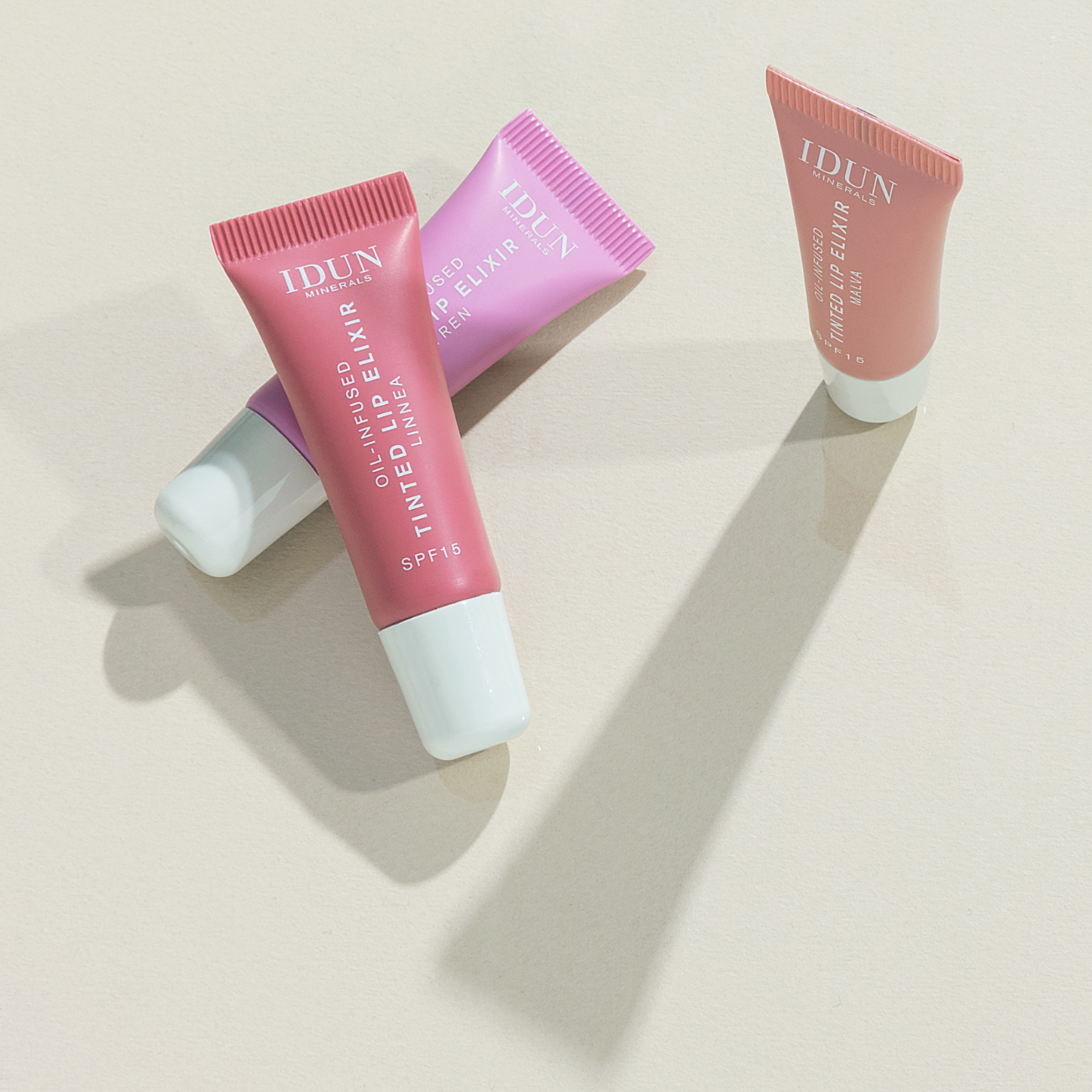 IDUN Minerals Lip Elixir in Syren, Malva and Linnea, vegan, cruelty-free, with a moisturizing, glossy finish and SPF 15.